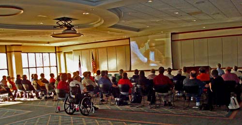 Photo of meeting attendees watching film